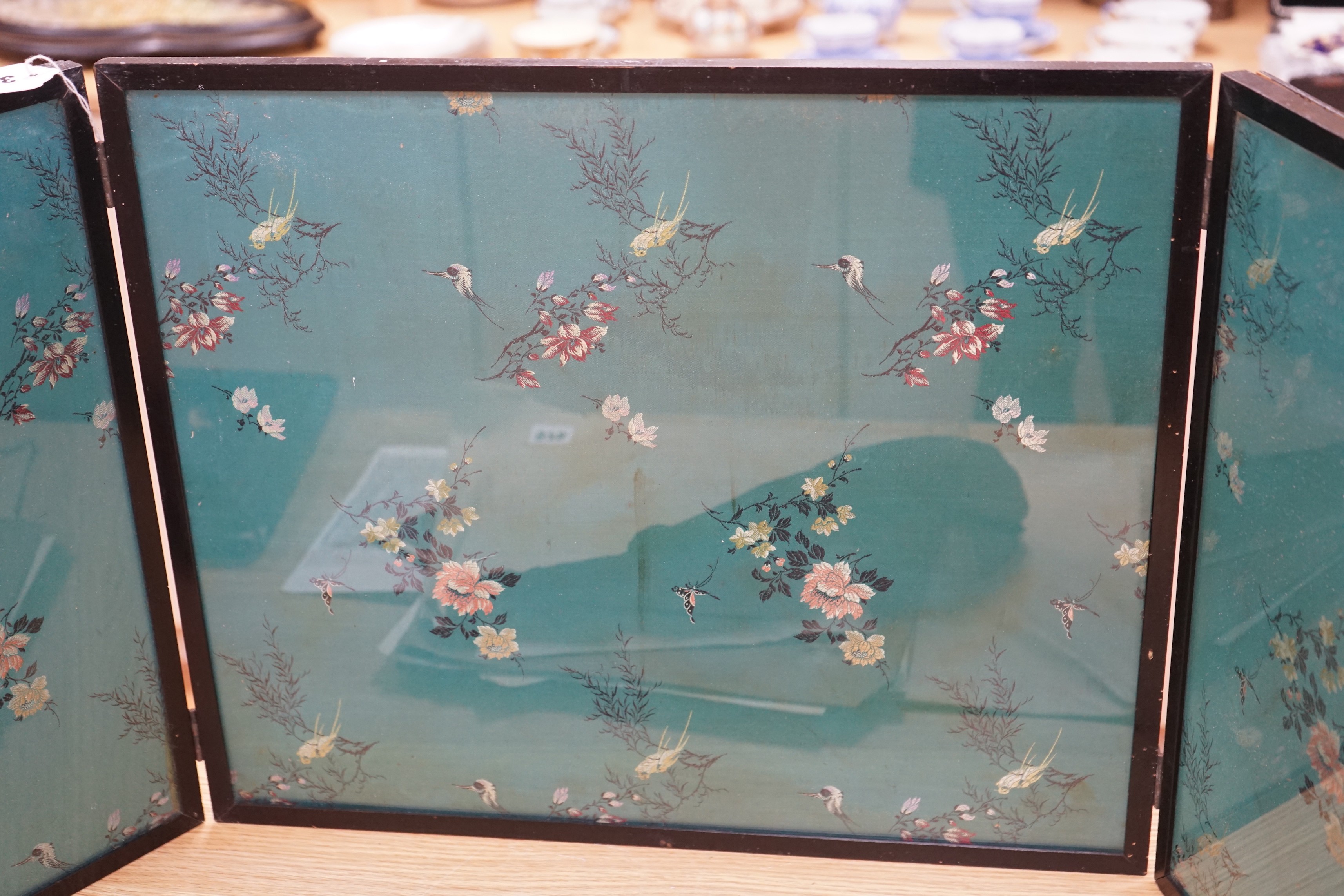 A Chinese embroidered silk inset three fold screen, largest panel 40 x 47cm